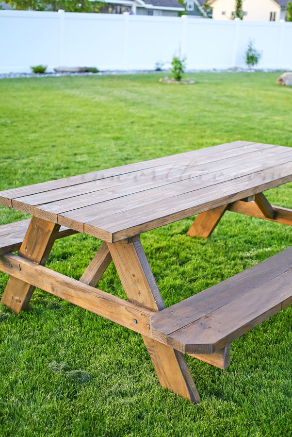 Warm cedar picnic table on green lawn